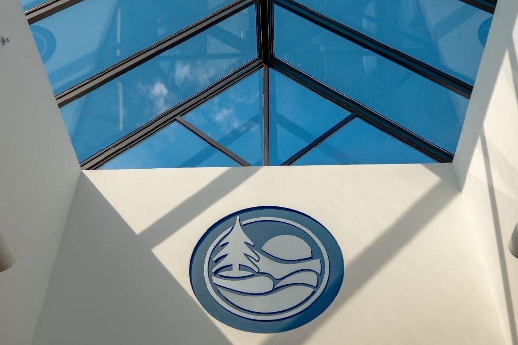 Photo of skylight at Ottawa County Fillmore complex with Ottawa County logo on the wall.